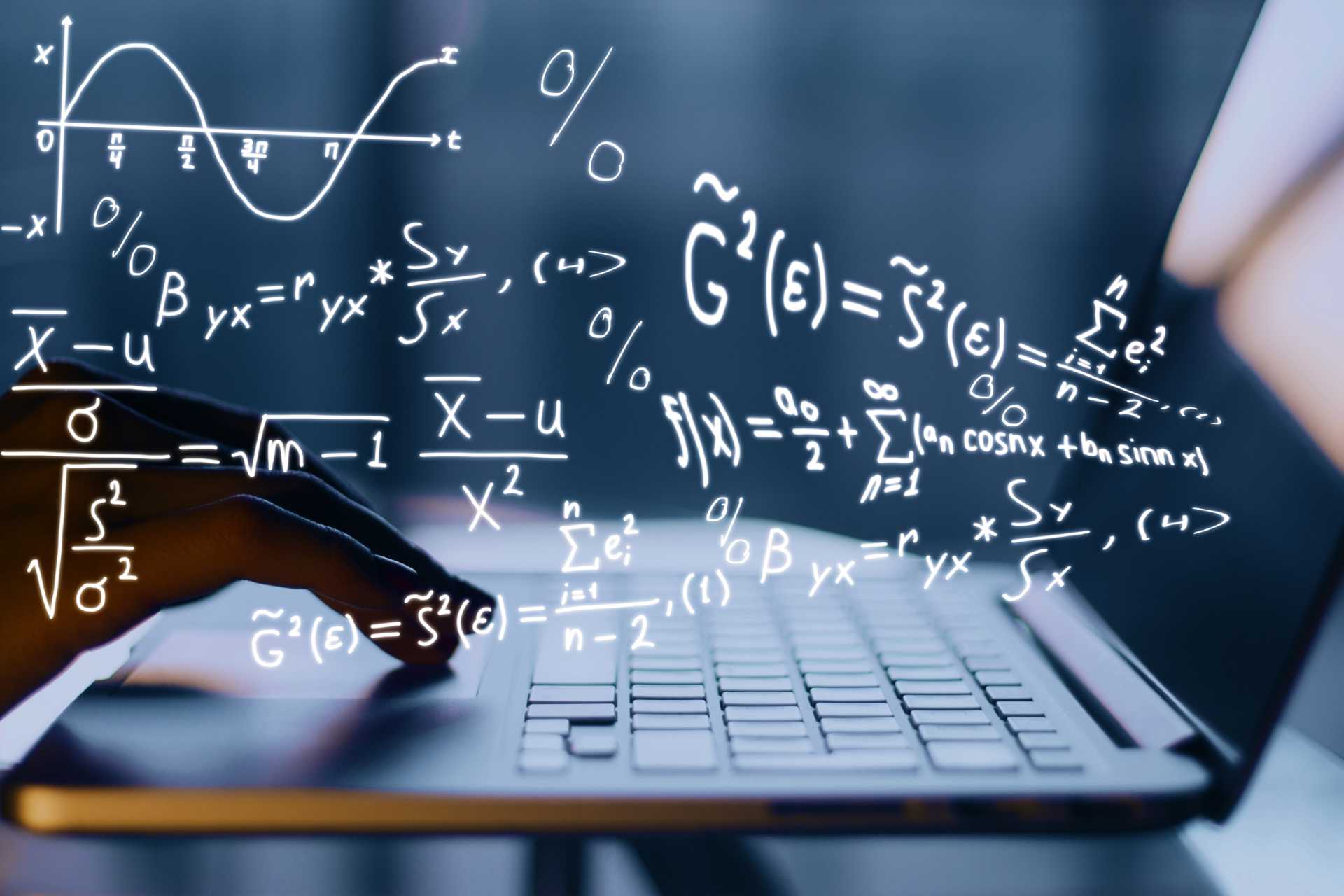 Hand taps on notebook. Mathematical formulas can be seen in the image.